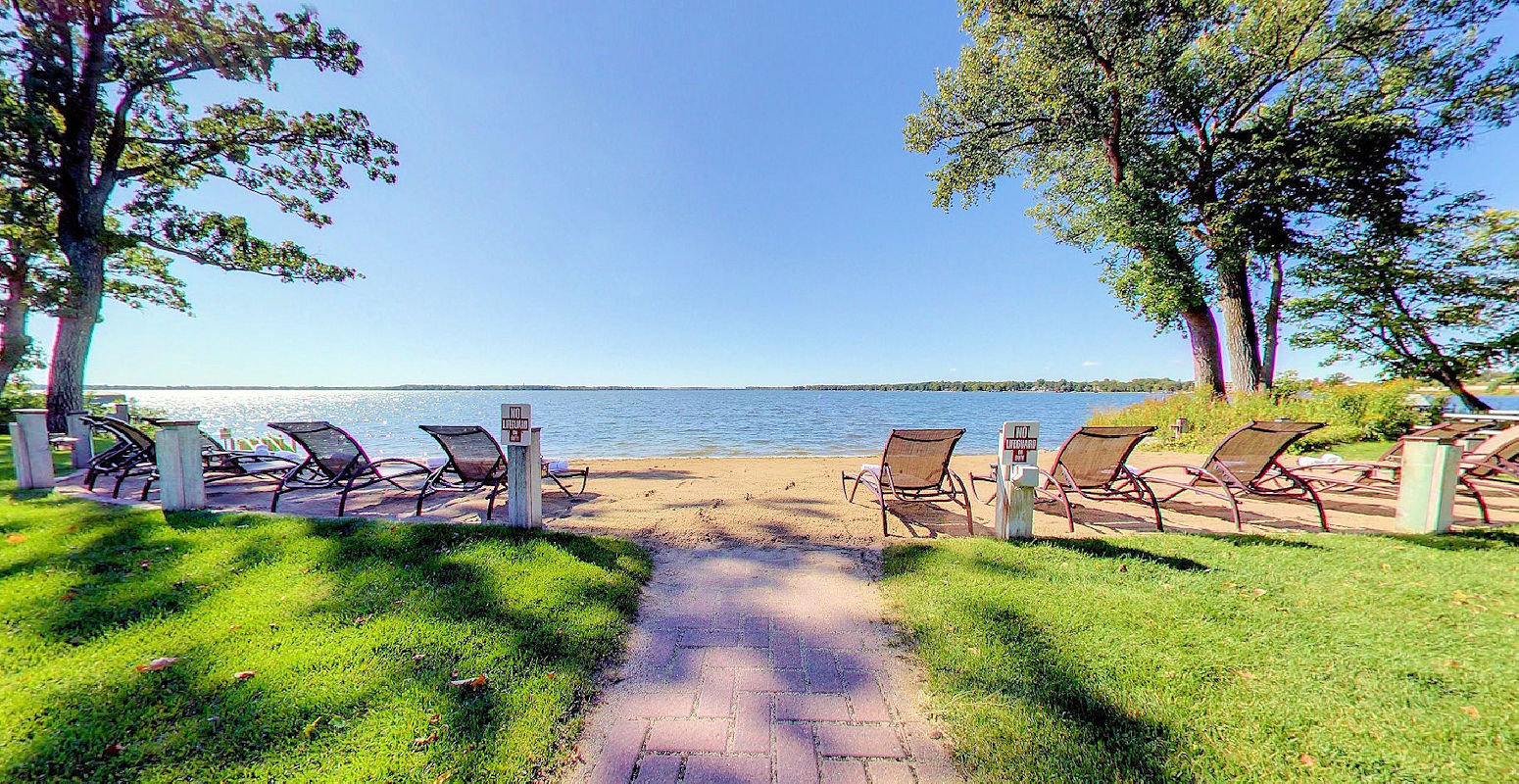 Beautiful morning before folks hit the lounge chairs on the private sandy beach at the Lodge on Lake Detroit