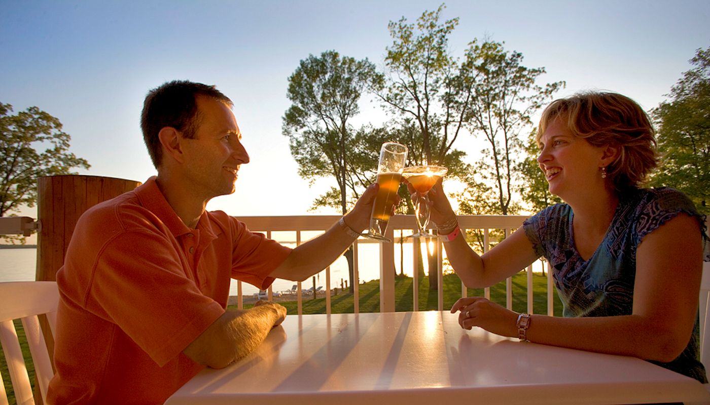Couple enjoying sunset drinks at The Lodge on Lake Detroit