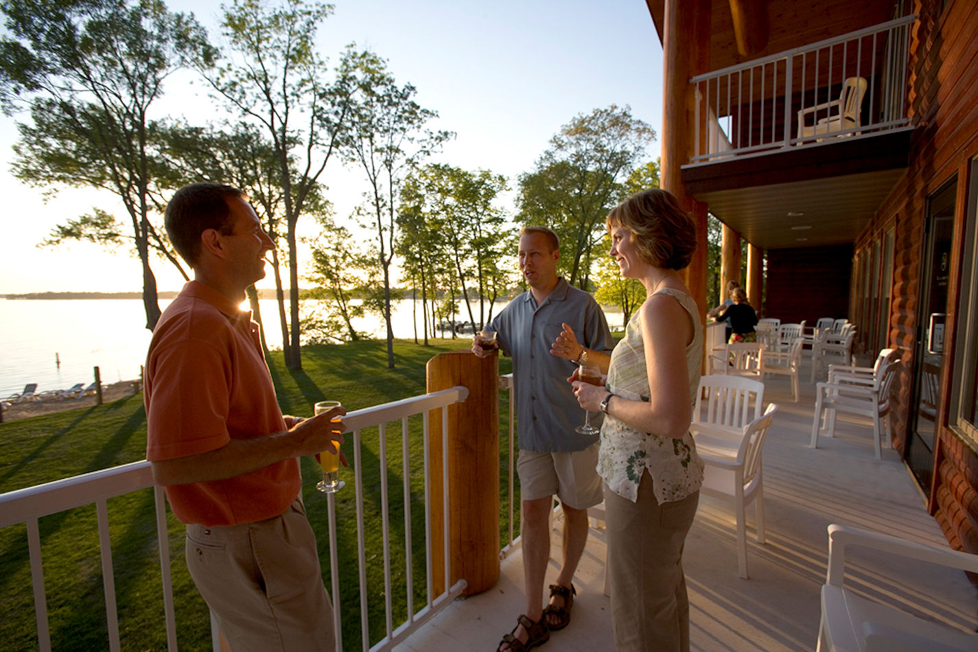 Guests enjoying sunset cocktails on the deck at The Lodge on Lake Detroit