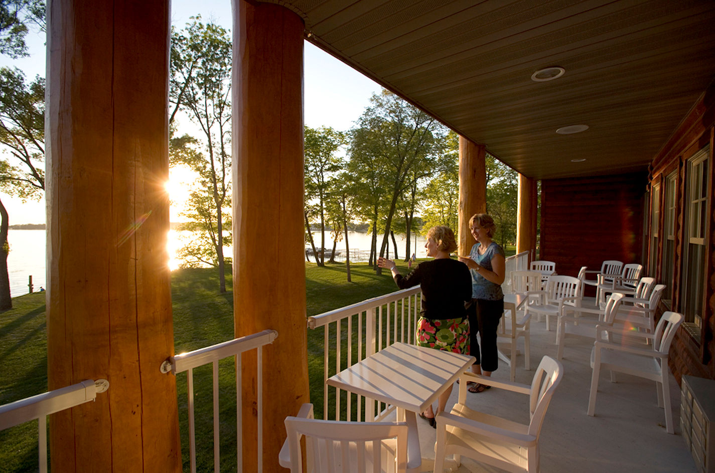 Couple enjoying sunset on the deck at The Lodge on Lake Detroit